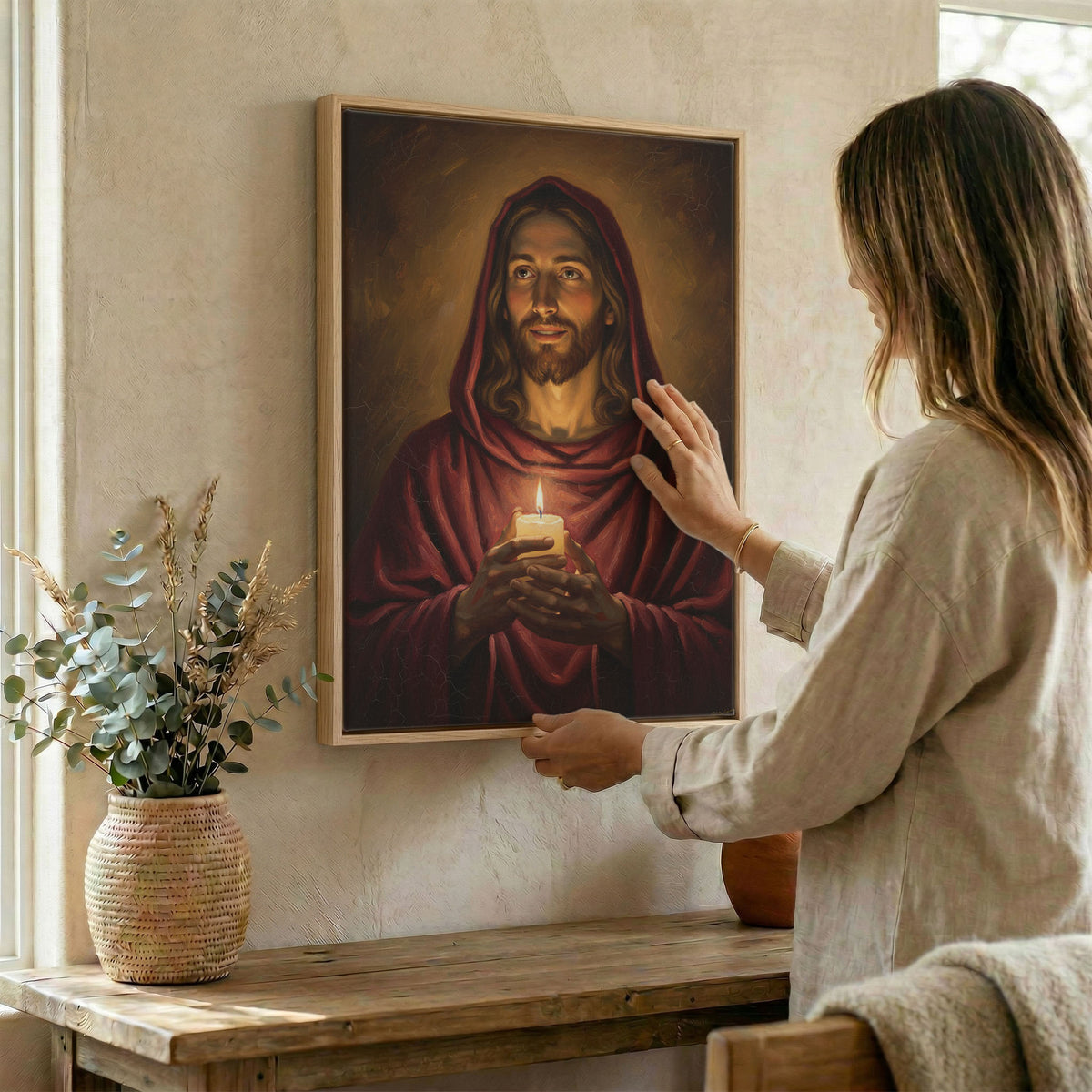 Woman hanging John 8:12 Jesus wall art in wood frame beside dried botanical arrangement