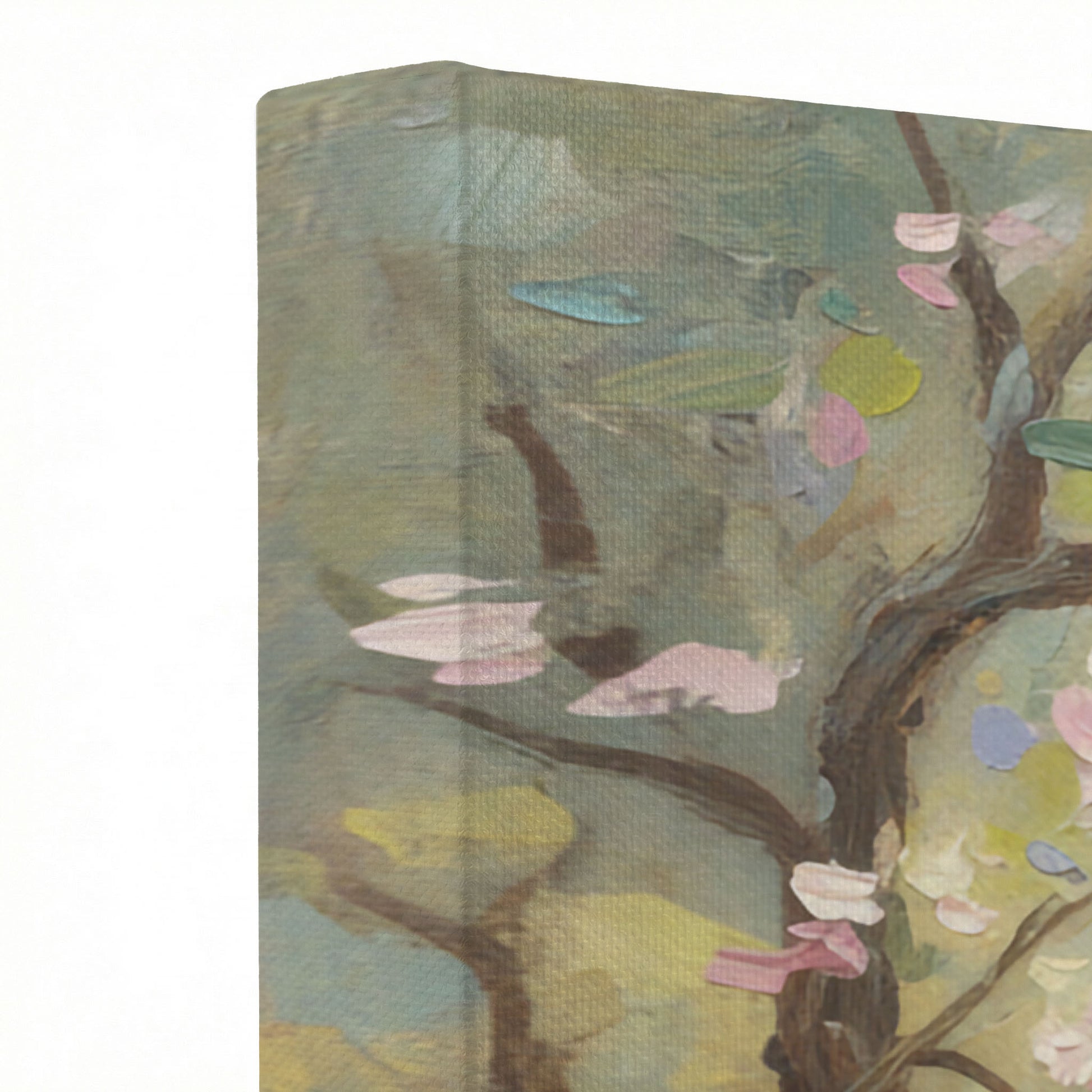 Close-up of canvas wrap edge showing oil painting texture with pink blossom branches and sage tones