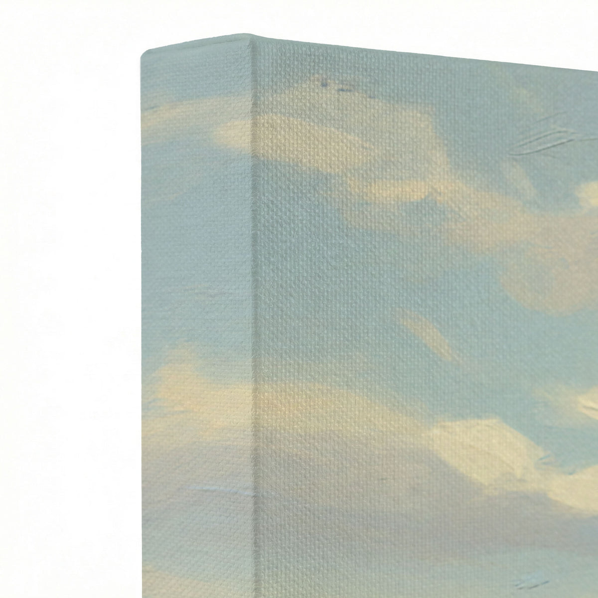 Close-up of canvas wrap edge showing oil painting texture with soft blue sky and white cloud tones