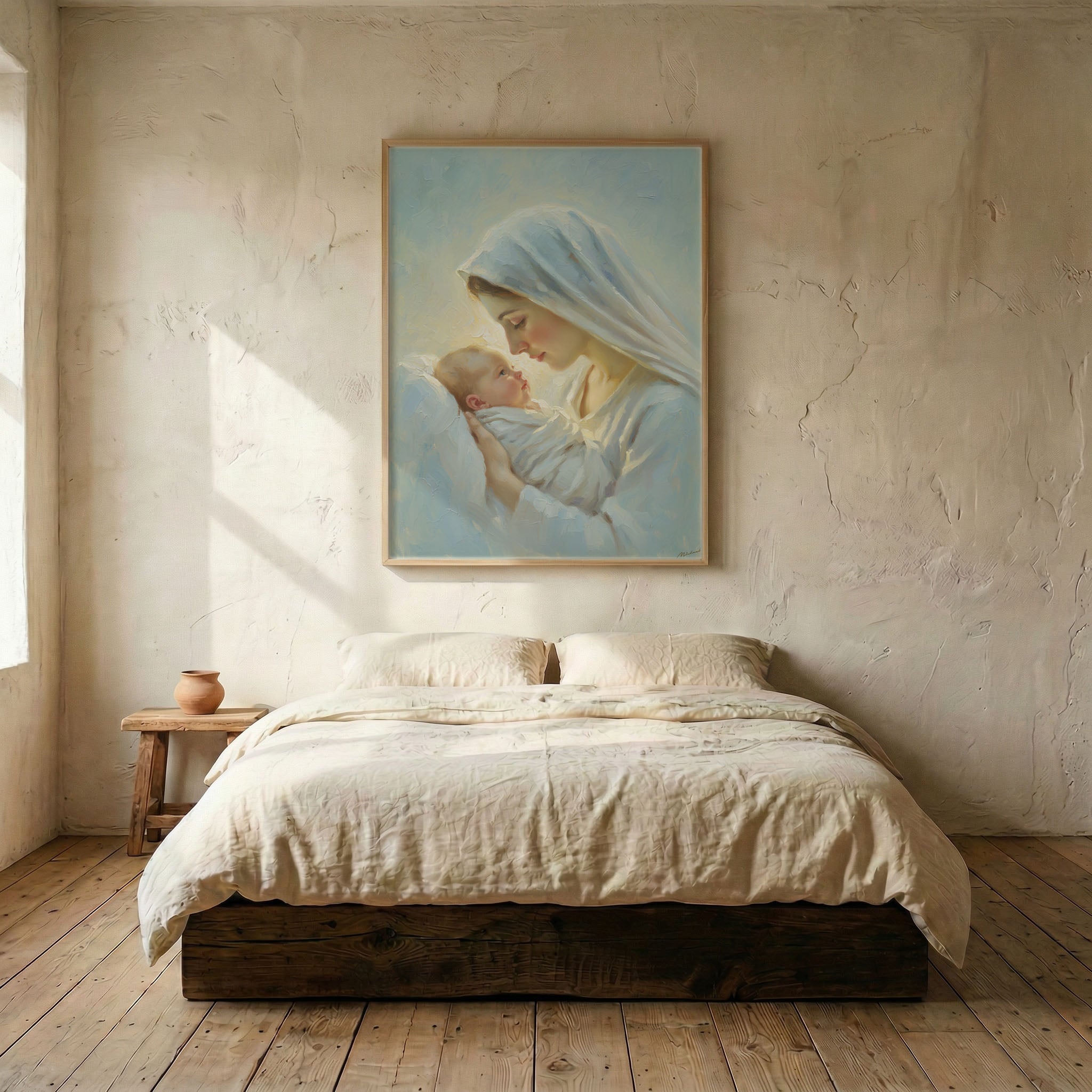 Virgin Mary holding Baby Jesus canvas print in wood frame mounted above linen platform bed in serene neutral bedroom